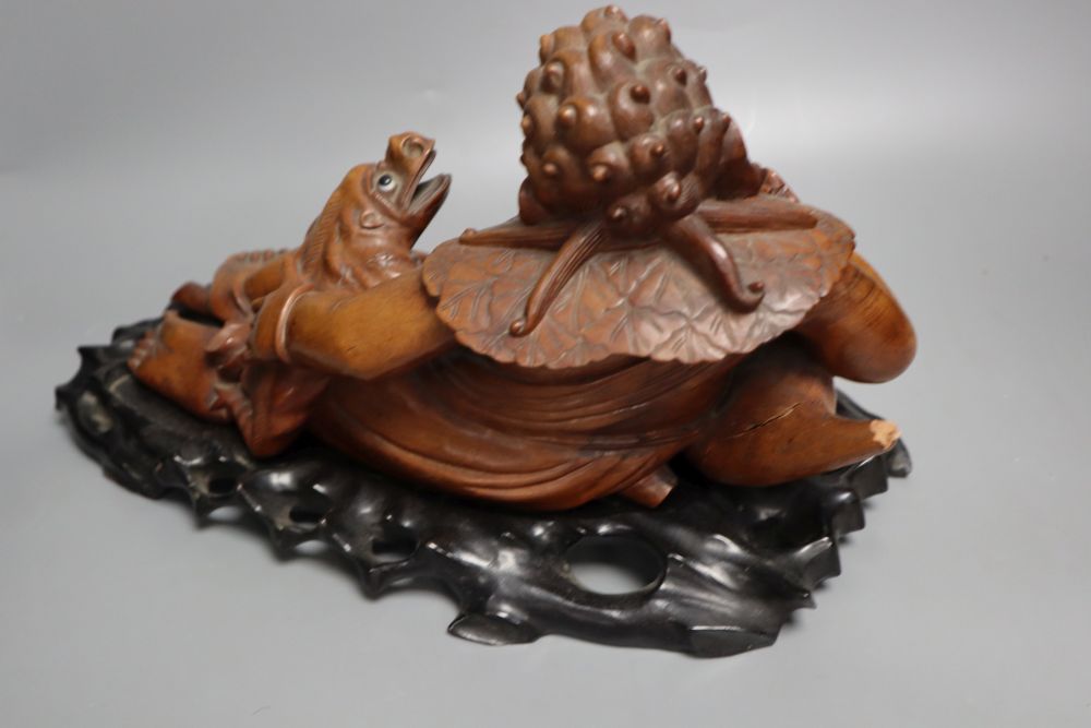 A Chinese hardwood group of Liu Hai and his three legged toad, early 20th century, together with an ebonised wood stand, length 36cm